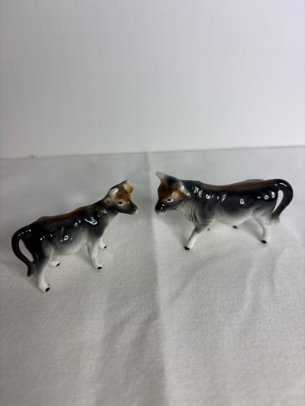 Pair of Ceramic Cow Figurines in Black, White and Brown
